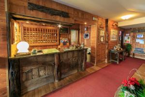 a kitchen with wooden walls and a red carpet at Hotel Meublé Furggen in Breuil-Cervinia