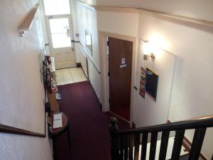 a stairway with a hallway with a door and a hallway at Brampton Guest House in Paignton
