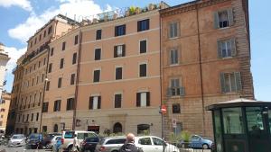 a large building with cars parked in front of it at Pantheon Hedonism in Rome