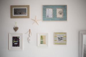 a white wall with pictures on it at Beachlands Hotel in Weston-super-Mare