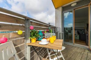 a table on the balcony of a house at Panoramic Pad with Free Parking - By My Getaways in Brighton & Hove