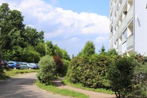 a building on a street next to a parking lot at Atelier Aleksandry in Gdynia