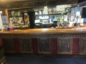 a bar in a pub with a lot of alcohol at Masons Arms in Skipton