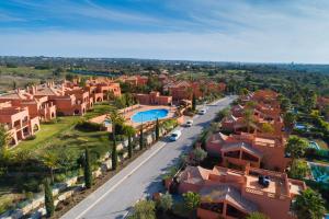 an aerial view of a residential neighborhood with a road and houses at Amendoeira Golf Resort in Armação de Pêra