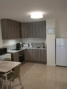 a kitchen with a white refrigerator and a table at Comfort in Adeje