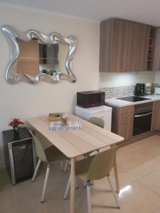 a kitchen with a table and a mirror on the wall at Comfort in Adeje