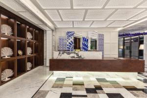 a lobby with a reception desk in a building at Kaya Palazzo Resort & Residences Le Chic Bodrum in Bodrum City