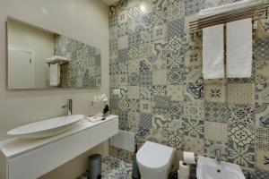 a bathroom with a sink and a toilet at Casa da Bandeira -Perfect Location-Beach front- Rooftop Pool by DreamvillasAlbufeira in Albufeira +21 photos