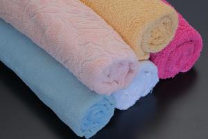 a group of four towels sitting on a table at D&N Hospedagem Lisboa in Lisbon +100 photos