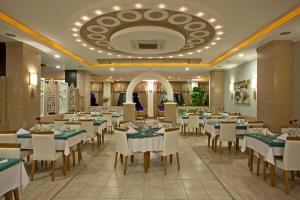 a restaurant with tables and chairs and a ceiling at Titan Select Hotel Ultra All Inclusive in Konaklı