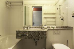 Ванная комната в Apartment Enzian mit Mitbenutzung SPA & Wellness - GRIWA RENT AG