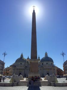 a monument in front of a building with a tower at La Roma di Cecilia in Rome