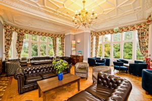 
a living room filled with furniture and a fire place at YHA Castleton Losehill Hall in Castleton
