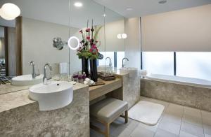 a bathroom with a sink and a tub at Crowne Plaza Changi Airport, an IHG Hotel in Singapore