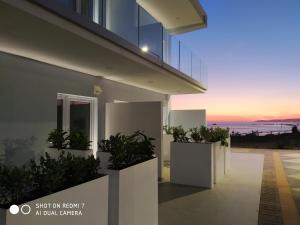 a view of a house with plants in planters at Terrazze Naos in San Leone