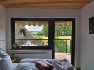 a bedroom with a window with a view of a yard at Pension Petersen in Bergen auf Rügen