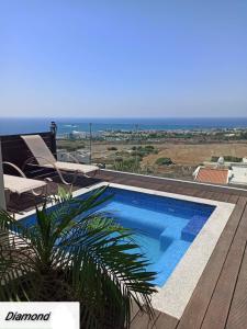 a swimming pool on a deck with a view of the ocean at Diamond Townhouse 17 in Paphos