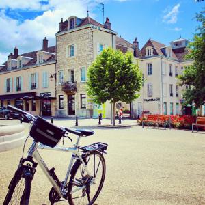 a bike parked in front of a building at La Dormance in Beaune