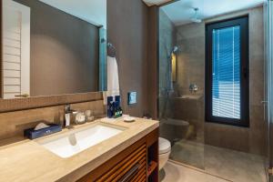 a bathroom with a sink and a shower and a toilet at Kaya Palazzo Resort & Residences Le Chic Bodrum in Bodrum City