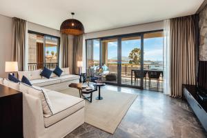 a living room with a couch and a table at Kaya Palazzo Resort & Residences Le Chic Bodrum in Bodrum City