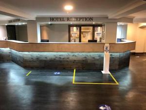 a hotel reception area in a building with a hotel reputation at Fairways Lodge & Leisure Club in Manchester