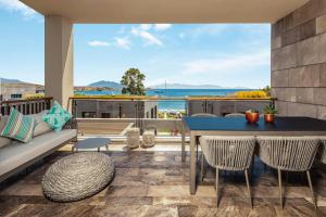 a patio with a couch and a table and chairs at Kaya Palazzo Resort & Residences Le Chic Bodrum in Bodrum City