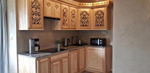 a kitchen with wooden cabinets and a counter top at Domek Melania in Zakopane