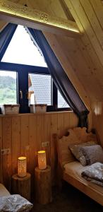 a bedroom with a bed and two tables with lamps at Domek Melania in Zakopane