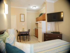 a living room with a kitchen and a dining room at Athens Hotel & Suites in Houston