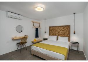a bedroom with a bed and a desk and chair at Pasithea Deluxe in Tripití