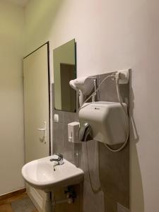 a bathroom with a white sink and a mirror at VIKI Kazimierz in Kraków +94 photos