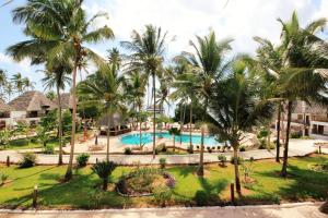 an aerial view of a resort pool with palm trees at Paradise Beach Resort & Spa in Uroa