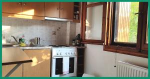 a kitchen with a white stove and a window at Kampos View Ikaria in Évdhilos