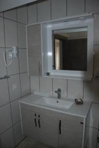 a white bathroom with a sink and a mirror at Bursa Park Apart Hotel in Bursa