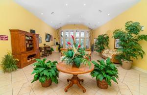 - un salon avec une table et des plantes dans l'établissement Official-Site The Villas at Seven Dwarfs 03, à Kissimmee
