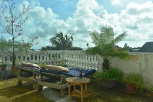 a patio with a white fence and a table and chairs at JamboHouse Lamu in Lamu