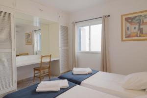 a bedroom with a bed and a chair and a mirror at Windmill Hill in Albufeira +28 photos