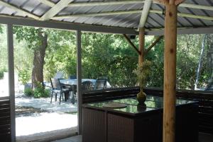a screened in porch with a table and chairs at VILLA TERRE NEUVE in Signes