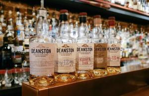 a bunch of bottles of whiskey sitting on a shelf at Ginger's in Stirling