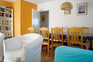 a living room with a dining room table and chairs at Bontemps Apartment in Timmendorfer Strand