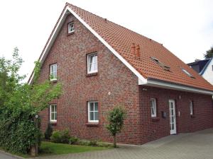 a red brick house with a red roof at Bontemps Apartment in Timmendorfer Strand