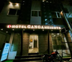 a motorcycle parked in front of a building at night at Hotel Ganga Heights in Haridwār