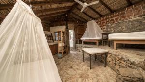 a wedding veil is hanging in a room with beds at Casa de las Olas in Mazunte