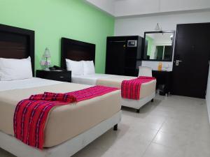 מיטה או מיטות בחדר ב-Hotel Parque Marimba