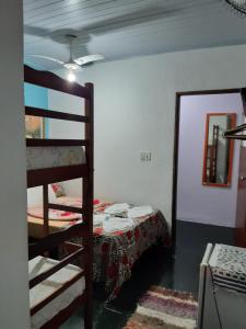 a room with a bunk bed and a ladder at Pousada da Helena Trindade in Trindade