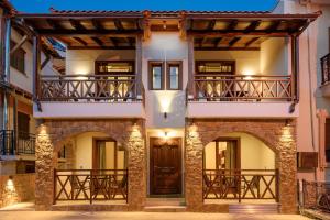 an exterior view of a house with two balconies at Arxontariki Suites in Ouranoupoli