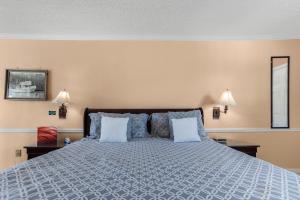 a bedroom with a blue bed with two pillows at The BoatHouse in Marco Island