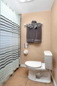 a bathroom with a toilet and a shower at The BoatHouse in Marco Island