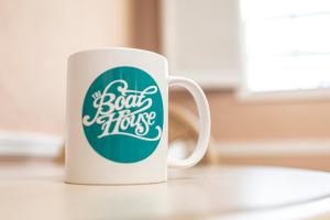 a coffee cup with the words boat hogs on it at The BoatHouse in Marco Island