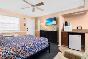 a hotel room with a bed and a microwave at The BoatHouse in Marco Island